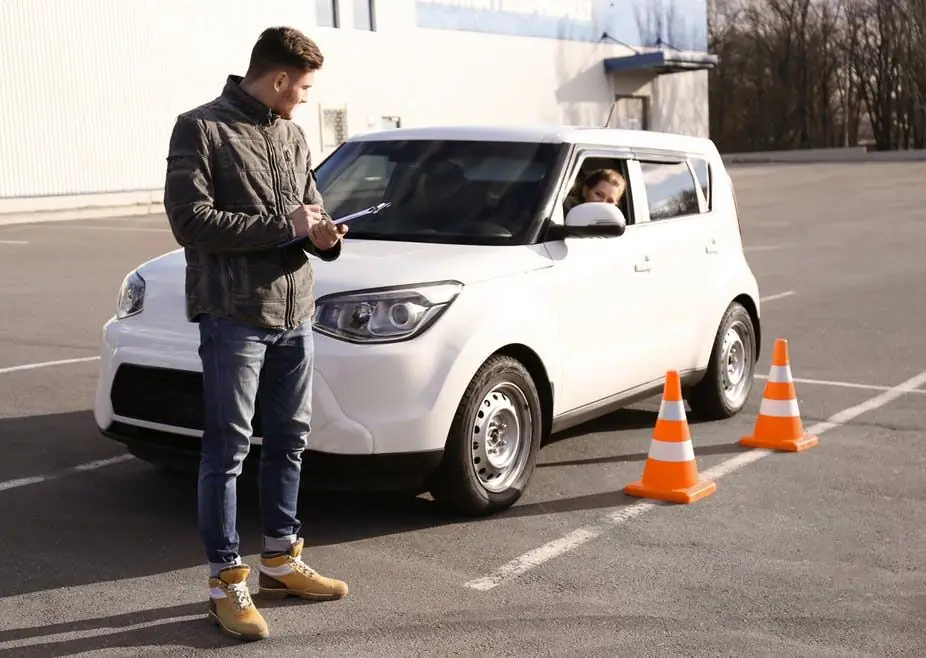 Driving instructor and student at a road test practice area